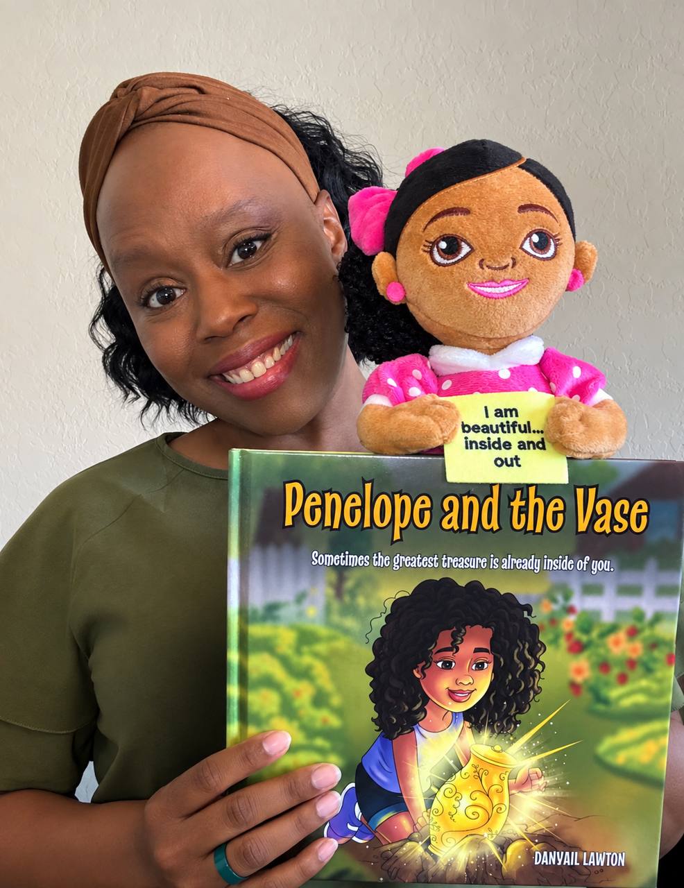 Author Danyail Lawton holding Penelope and the Vase and the Penelope doll